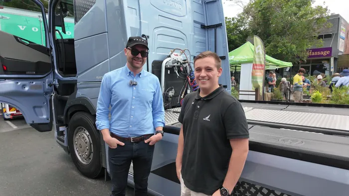 Adam talking with a Volvo representative about the new Volvo electric truck